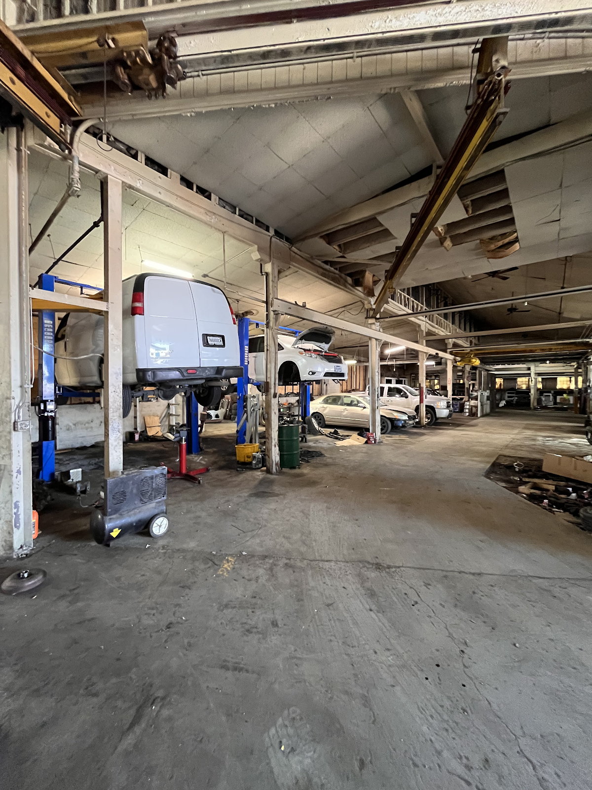 Shop floor — vehicles on hydraulic lifts